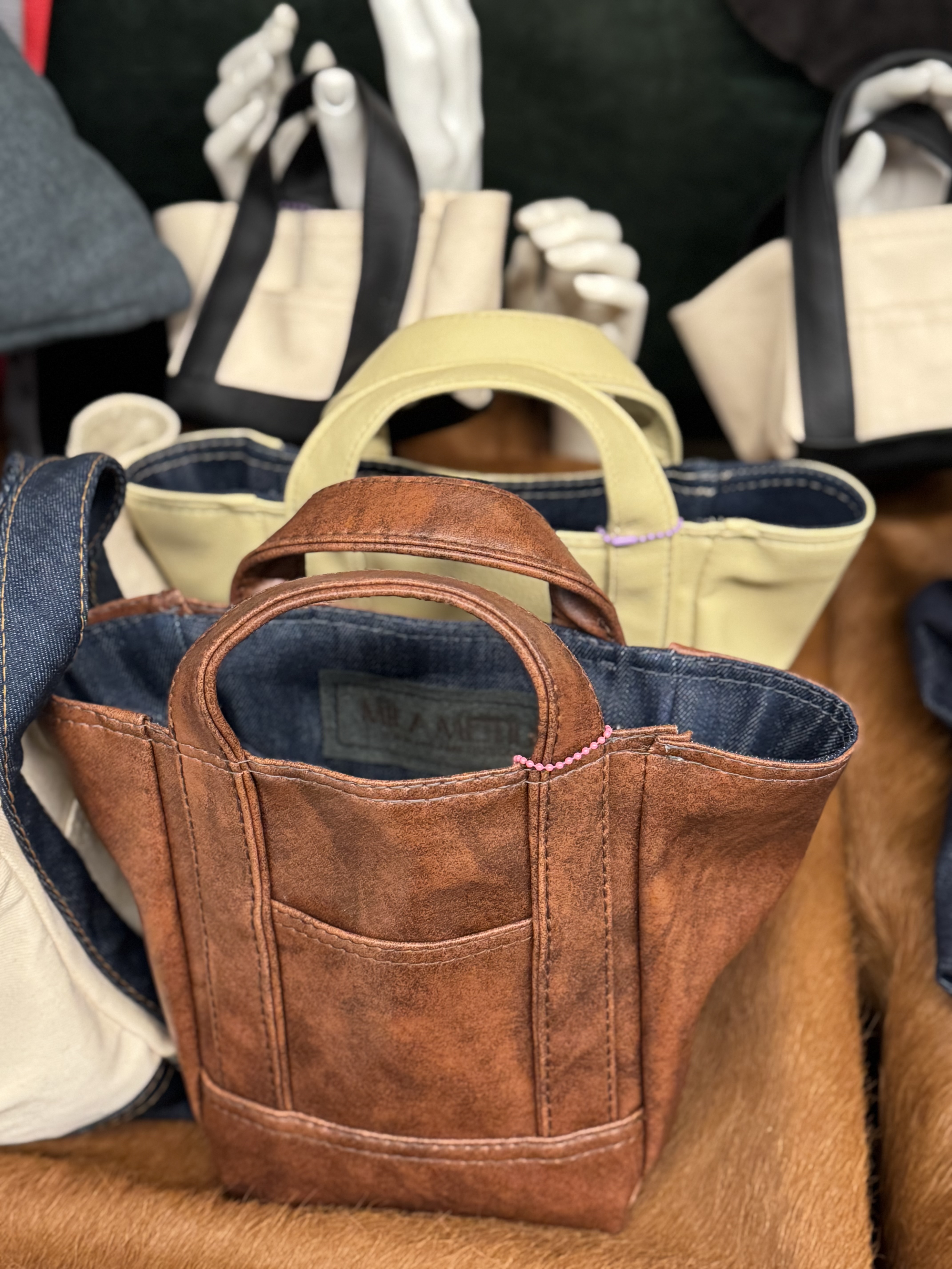 Brown and cream colored Mila Metius bags on display